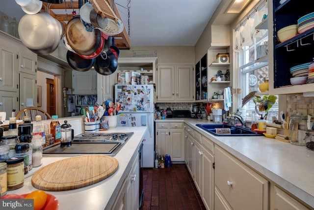 289 Newman Ave, Harrisonburg, VA 22801 - kitchen with open shelves, a sink, light countertops, brick flooring, and freestanding refrigerator
