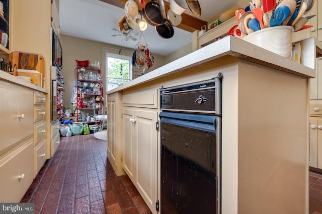 289 Newman Ave, Harrisonburg, VA 22801 - kitchen with brick floors, cream cabinets, and light countertops