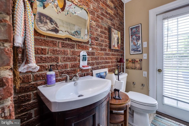 289 Newman Ave, Harrisonburg, VA 22801 - half bathroom featuring brick wall, vanity, and toilet