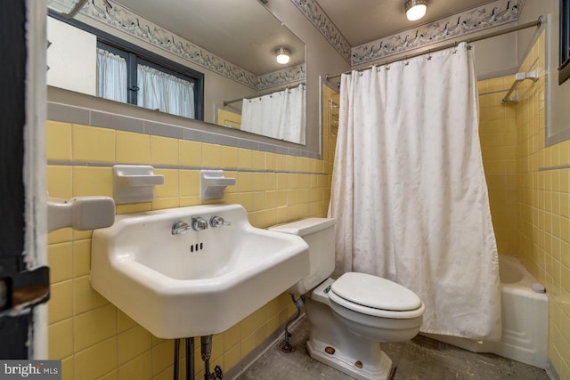 289 Newman Ave, Harrisonburg, VA 22801 - bathroom featuring tile walls, toilet, shower / bathtub combination with curtain, and a wainscoted wall