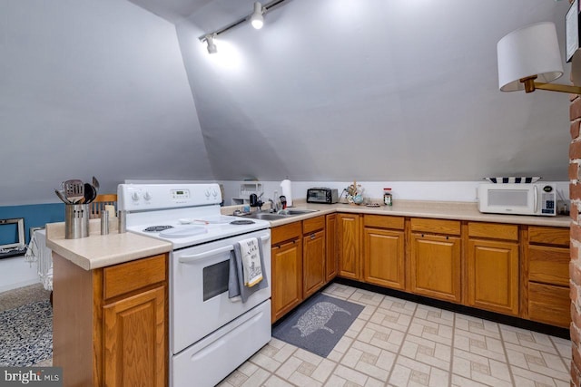 289 Newman Ave, Harrisonburg, VA 22801 - kitchen featuring white appliances, rail lighting, light countertops, vaulted ceiling, and a peninsula