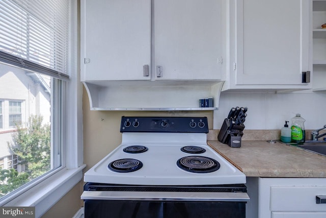 289 Newman Ave, Harrisonburg, VA 22801 - kitchen featuring white range with electric stovetop, white cabinets, light countertops, open shelves, and a sink