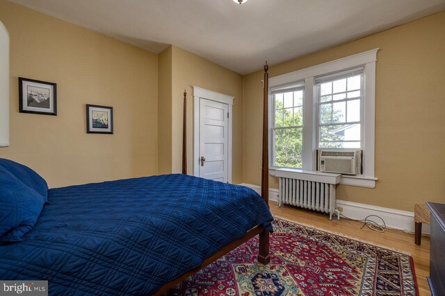 289 Newman Ave, Harrisonburg, VA 22801 - bedroom featuring radiator, wood finished floors, baseboards, and cooling unit
