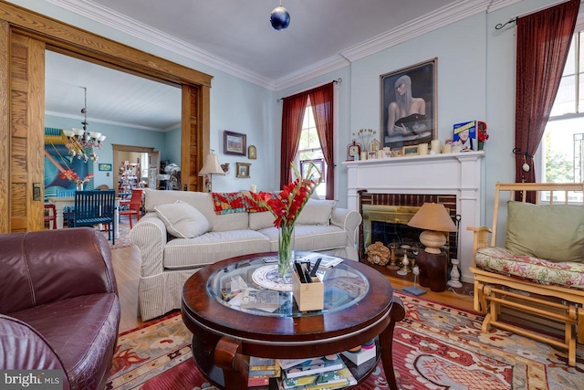 289 Newman Ave, Harrisonburg, VA 22801 - living room with a chandelier, wood finished floors, crown molding, and a brick fireplace