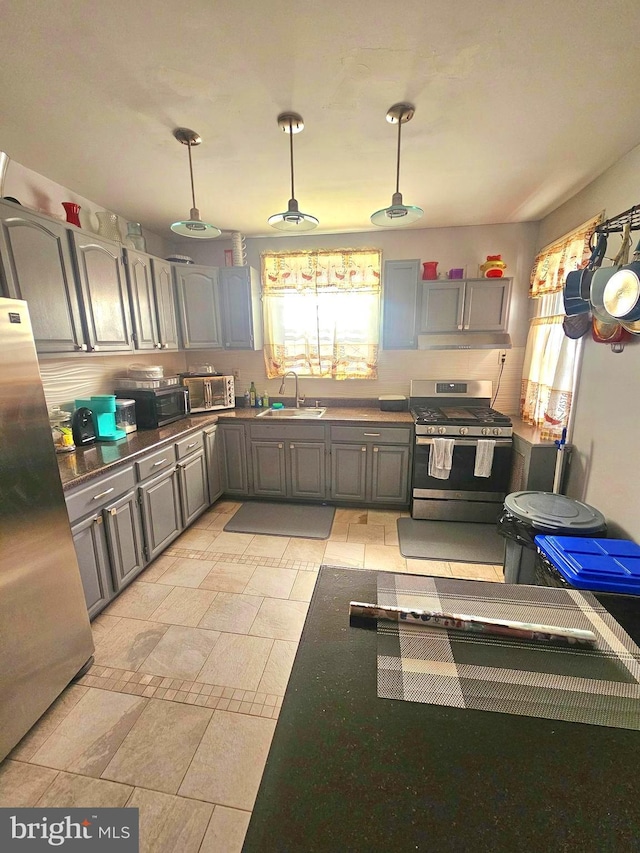 3908 Bennington St, Philadelphia, PA 19124 - kitchen with stainless steel appliances, a sink, gray cabinets, decorative light fixtures, and dark countertops