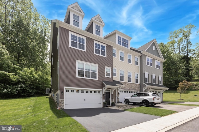 404 Rock Run Cir, Broomall, PA 19008 - view of front of house with asphalt driveway, a garage, a front lawn, and stone siding