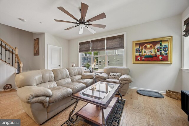 404 Rock Run Cir, Broomall, PA 19008 - living area featuring a ceiling fan, stairs, baseboards, and light wood-style flooring