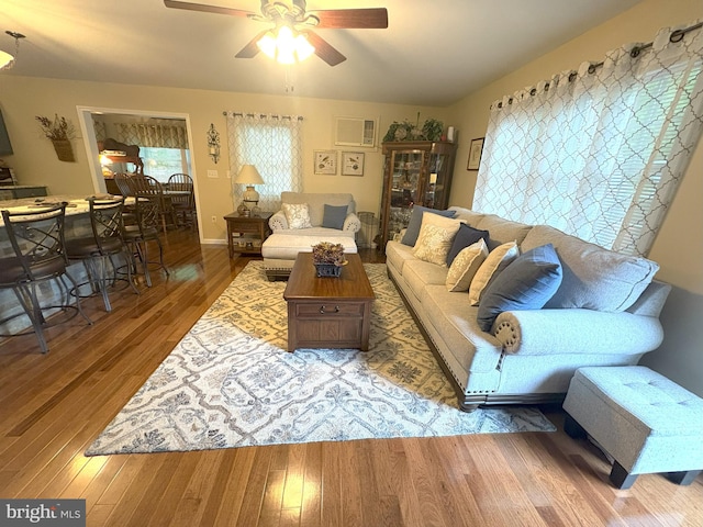 living area with ceiling fan and wood finished floors