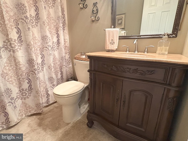bathroom featuring toilet, vanity, and tile patterned floors