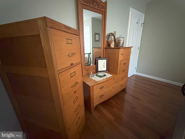 hall with dark wood-style floors and baseboards
