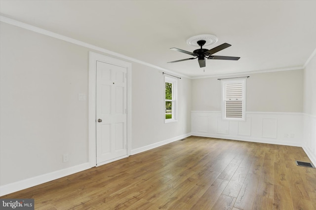 322 S Progress Ave, Harrisburg, PA 17109 - empty room with wood finished floors, a ceiling fan, ornamental molding, and a wainscoted wall