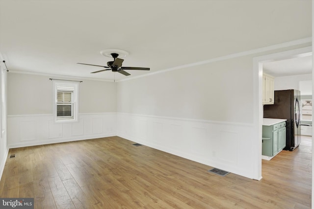 322 S Progress Ave, Harrisburg, PA 17109 - spare room with a ceiling fan, light wood-type flooring, plenty of natural light, wainscoting, and ornamental molding