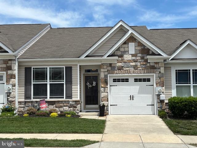 42 Cresthaven Ln, Dover, DE 19901 - craftsman-style home with stone siding, driveway, an attached garage, and a shingled roof
