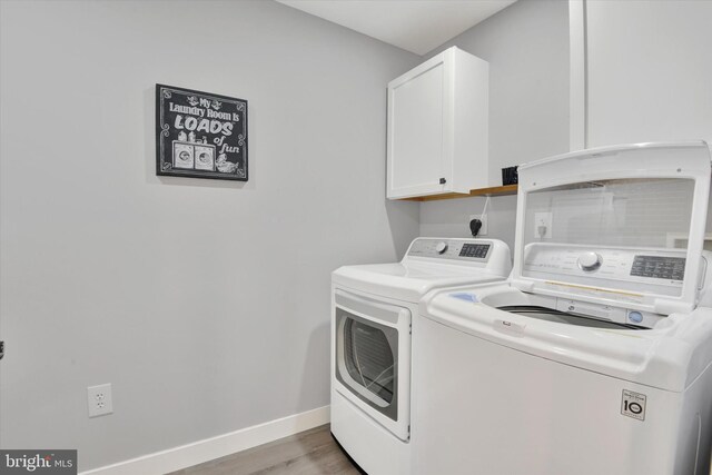 16010 Four Points Bridge Rd, Emmitsburg, MD 21727 - laundry area with cabinet space, washer and dryer, baseboards, and light wood-style floors