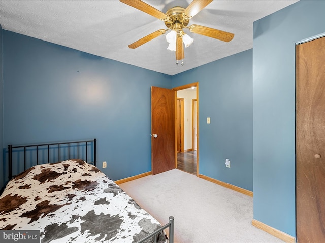 979 John Brown Farm Rd, Harpers Ferry, WV 25425 - bedroom with baseboards, carpet, ceiling fan, a closet, and a textured ceiling