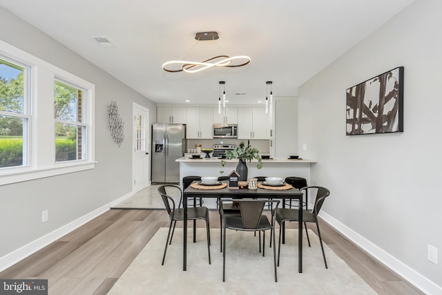 2017 Fairlane Rd, Bel Air, MD 21015 - dining space with light wood-style flooring, baseboards, and a chandelier