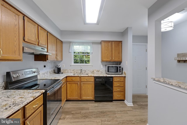 8822 Tanglewood Ln, Manassas, VA 20110 - kitchen featuring appliances with stainless steel finishes, under cabinet range hood, a sink, light wood-type flooring, and light stone counters