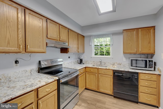8822 Tanglewood Ln, Manassas, VA 20110 - kitchen featuring appliances with stainless steel finishes, under cabinet range hood, light wood-type flooring, a sink, and light stone counters