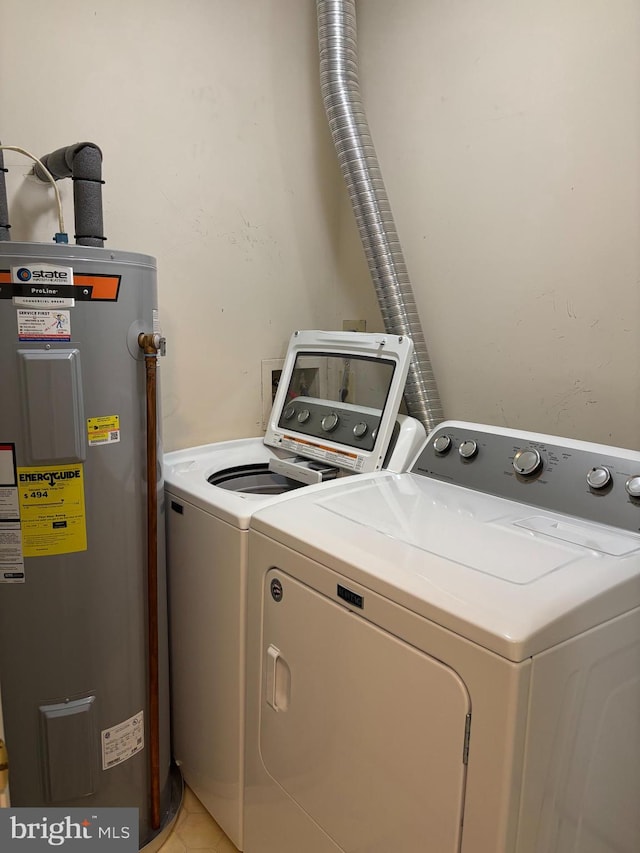 8822 Tanglewood Ln, Manassas, VA 20110 - laundry area with electric water heater, washing machine and clothes dryer, and light tile patterned floors