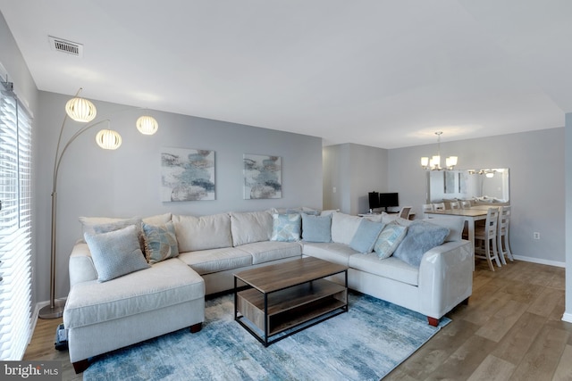 8822 Tanglewood Ln, Manassas, VA 20110 - living area with a chandelier, wood finished floors, and baseboards