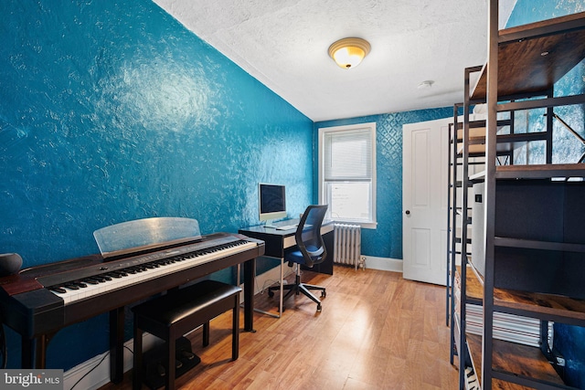 1409 S Clarion St, Philadelphia, PA 19147 - office space with radiator heating unit, wood finished floors, vaulted ceiling, healthy amount of natural light, and a textured ceiling