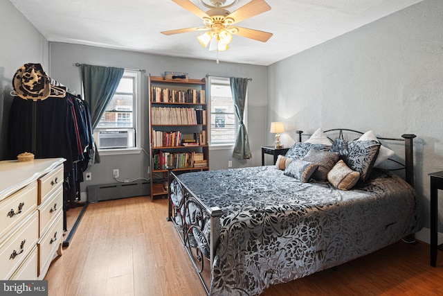 1409 S Clarion St, Philadelphia, PA 19147 - bedroom with light wood-type flooring, a baseboard heating unit, a ceiling fan, and cooling unit
