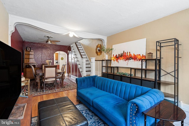 1409 S Clarion St, Philadelphia, PA 19147 - living area featuring arched walkways, stairs, wood finished floors, ceiling fan, and baseboards