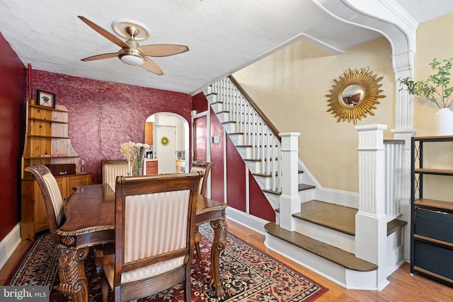 1409 S Clarion St, Philadelphia, PA 19147 - dining room with arched walkways, ceiling fan, wood finished floors, stairs, and baseboards