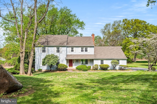 1050 Powderhorn Dr, Glen Mills, PA 19342 - view of front of property featuring a chimney, a porch, a front yard, and a shingled roof