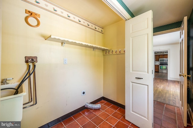 1050 Powderhorn Dr, Glen Mills, PA 19342 - laundry area with dark tile patterned flooring, washer hookup, baseboards, and hookup for an electric dryer