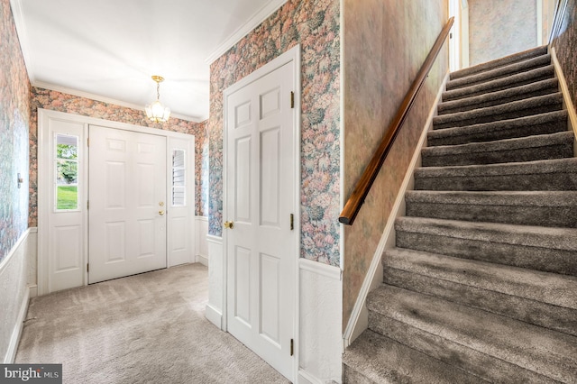 1050 Powderhorn Dr, Glen Mills, PA 19342 - foyer entrance with wallpapered walls, stairs, carpet flooring, and crown molding