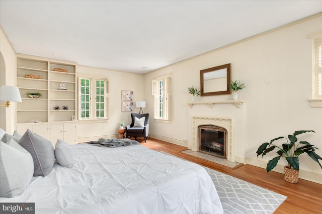 3419 Lowell St NW, Washington, DC 20016 - bedroom featuring wood finished floors, a fireplace, and crown molding