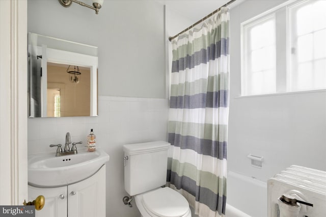 3419 Lowell St NW, Washington, DC 20016 - bathroom with vanity, tile walls, and shower / tub combo