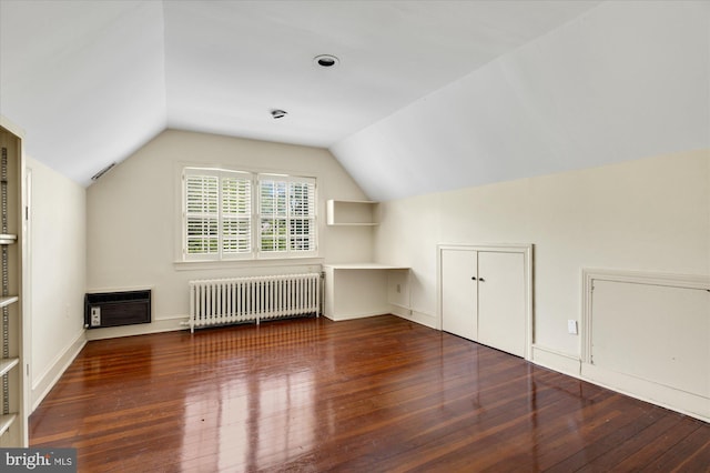 3419 Lowell St NW, Washington, DC 20016 - additional living space with radiator heating unit, hardwood / wood-style flooring, vaulted ceiling, and heating unit