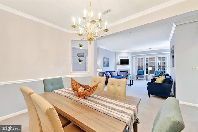 dining area with light colored carpet, a chandelier, crown molding, a glass covered fireplace, and baseboards