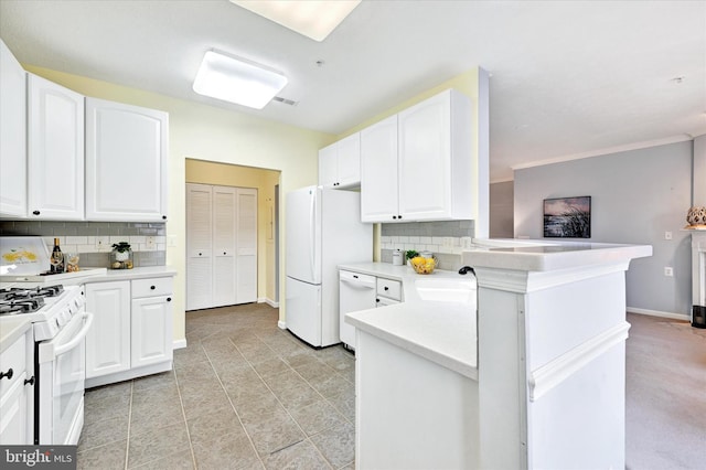 kitchen featuring white appliances, tasteful backsplash, white cabinetry, and light countertops