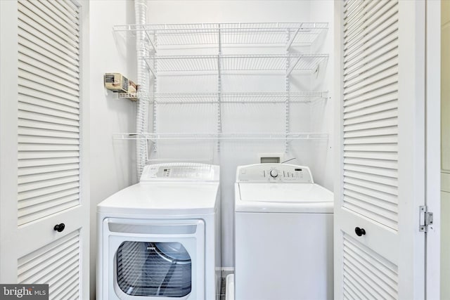 washroom with independent washer and dryer