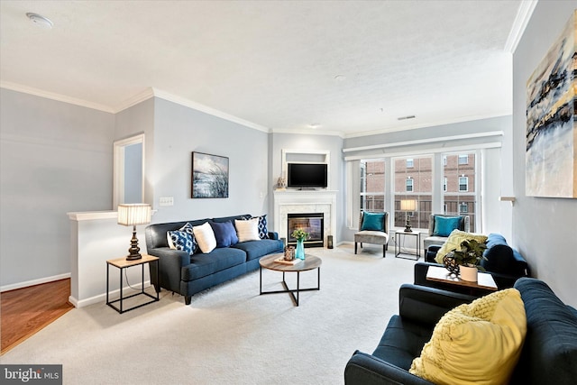 carpeted living room with a premium fireplace, ornamental molding, and baseboards