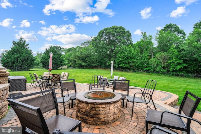 310 Nicklaus Ct, Woolwich Twp, NJ 08085 - view of patio / terrace featuring a fire pit, outdoor dining space, and view of scattered trees