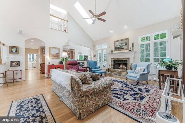11709 Pine Tree Dr, Fairfax, VA 22033 - living room featuring arched walkways, light wood finished floors, plenty of natural light, and high vaulted ceiling