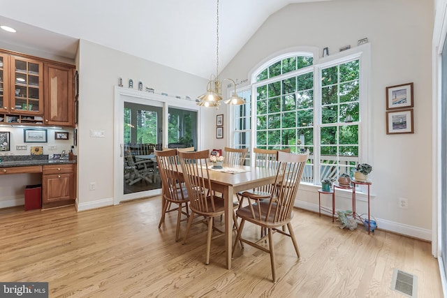11709 Pine Tree Dr, Fairfax, VA 22033 - dining space featuring light wood finished floors, vaulted ceiling, baseboards, and a chandelier