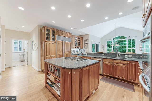 11709 Pine Tree Dr, Fairfax, VA 22033 - kitchen with appliances with stainless steel finishes, a sink, brown cabinetry, light wood-type flooring, and lofted ceiling