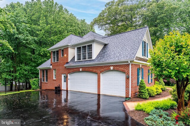 11709 Pine Tree Dr, Fairfax, VA 22033 - view of front of property featuring roof with shingles, driveway, brick siding, and a garage