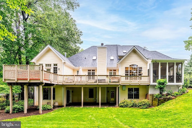 11709 Pine Tree Dr, Fairfax, VA 22033 - rear view of house featuring a sunroom, a wooden deck, roof with shingles, and a lawn