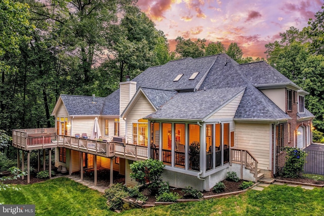 11709 Pine Tree Dr, Fairfax, VA 22033 - back of house at dusk with roof with shingles, a sunroom, a wooden deck, and a chimney