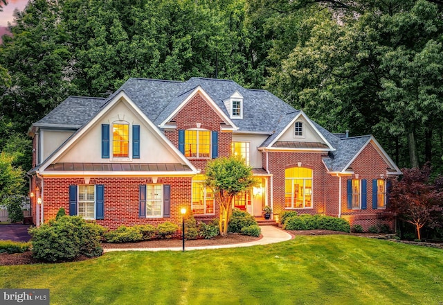 11709 Pine Tree Dr, Fairfax, VA 22033 - view of front of home with brick siding, a front yard, a standing seam roof, and roof with shingles