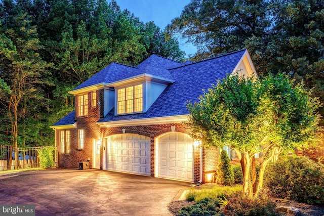 11709 Pine Tree Dr, Fairfax, VA 22033 - view of front facade featuring roof with shingles, concrete driveway, brick siding, and a garage
