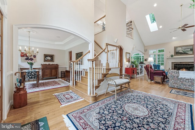 11709 Pine Tree Dr, Fairfax, VA 22033 - entryway featuring a high ceiling, stairs, arched walkways, wood finished floors, and a chandelier