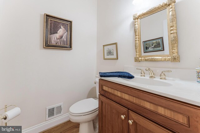 11709 Pine Tree Dr, Fairfax, VA 22033 - bathroom featuring vanity, toilet, wood finished floors, and baseboards