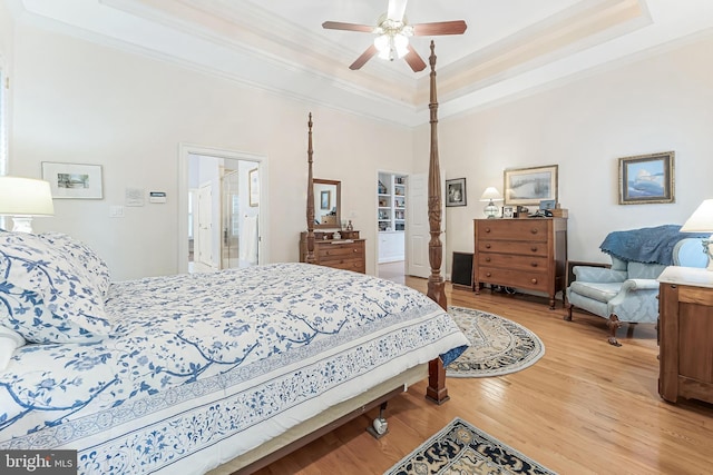 11709 Pine Tree Dr, Fairfax, VA 22033 - bedroom with ornamental molding, a raised ceiling, light wood-style flooring, and a ceiling fan